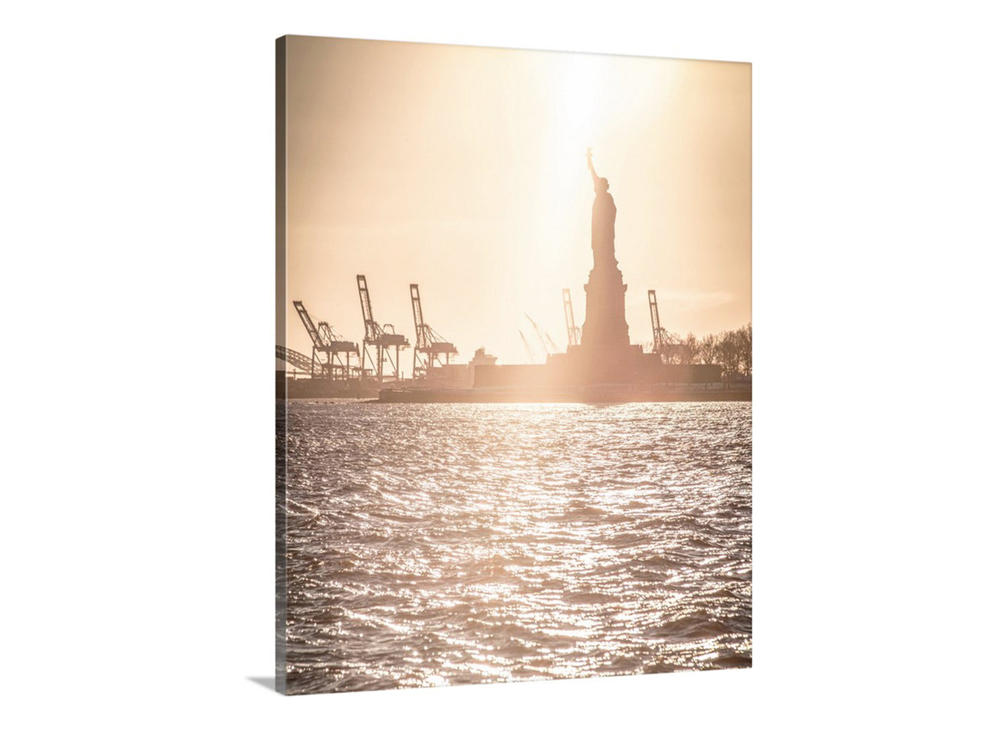 Silhouette of the Statue of Liberty at sunset with cargo ships in the background. Statue of Liberty Picture at Hudson River New York City at Sunset