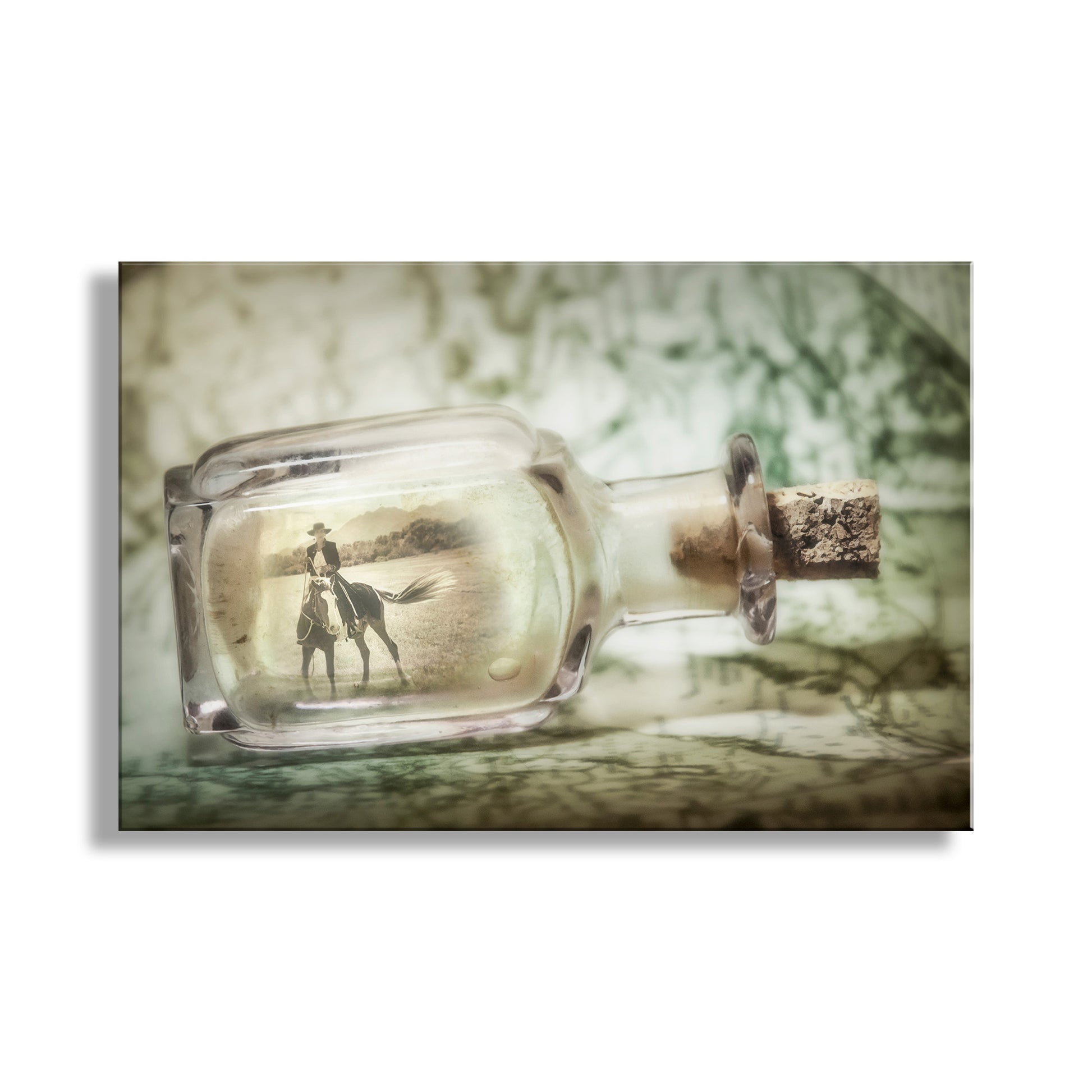 Glass bottle with cork stopper containing a photo of a person and horse on a textured background. Fine Art Print with Horsewoman | Equestrian Artwork with Spanish Barb Horse