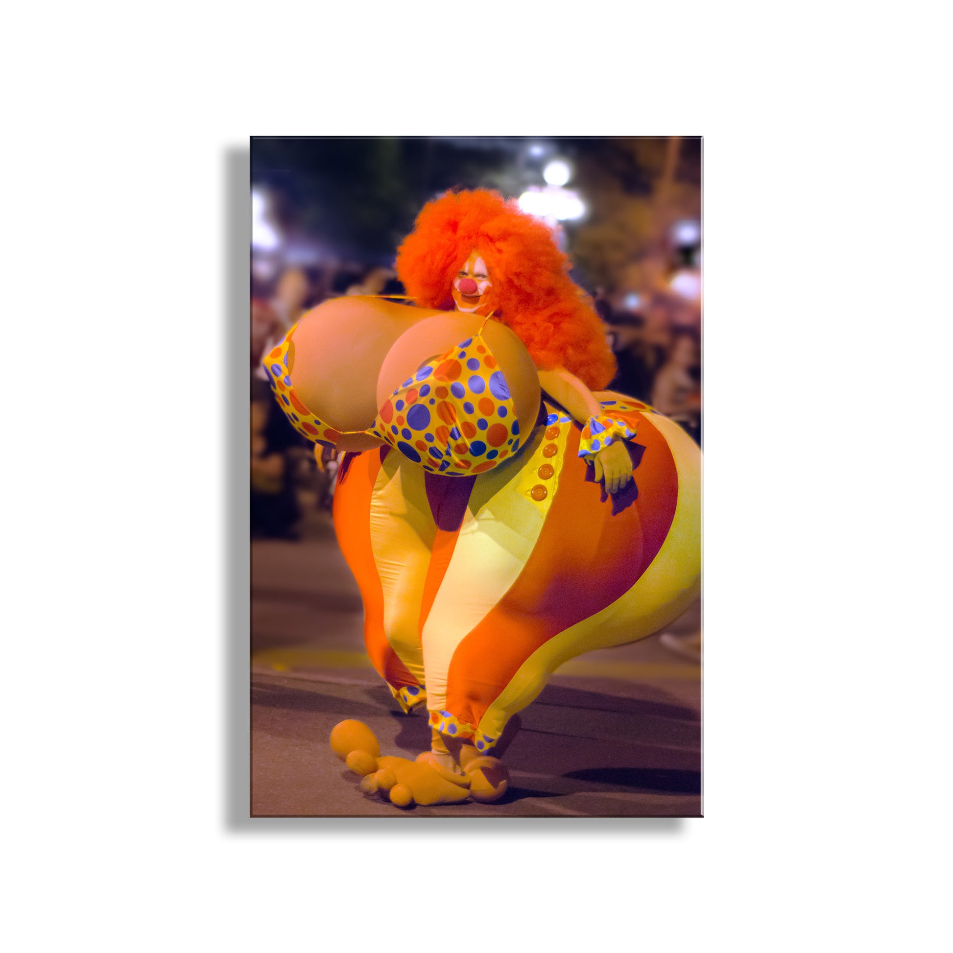 Person in a colorful inflatable costume with a clown wig at night. Day of the Dead Tucson Arizona Street Photography of All Souls Procession