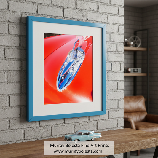 The image is a close-up of a red car hood, showcasing a chrome emblem or emblem on the hood. Vintage Red Chevrolet 210 Car Art Print - Classic Chevy Decor by Murray Bolesta