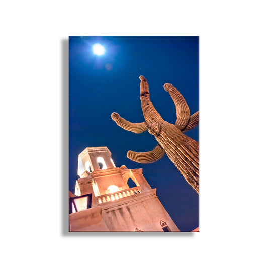 Cactus and building against a blue sky with moon. San Xavier Spanish Mission Print at Night with Cactus Moon in Tucson Arizona