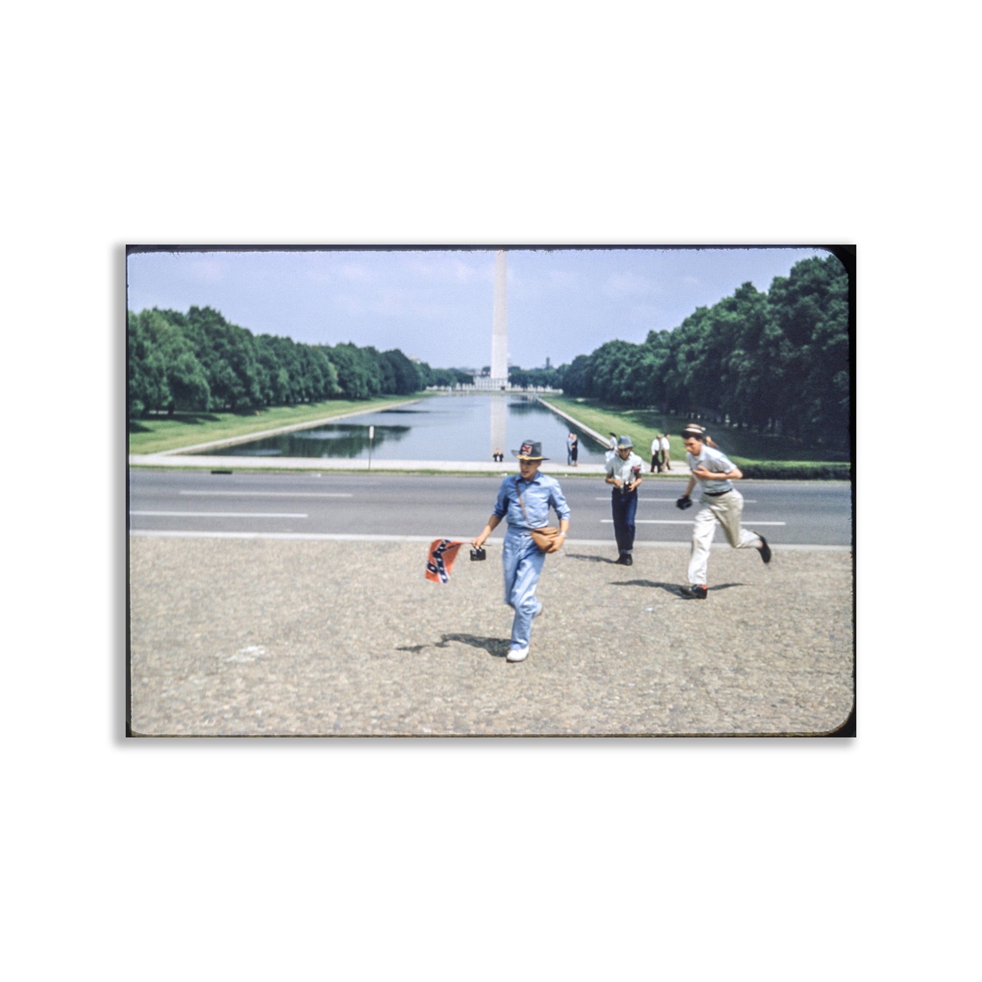 Three people in sports attire standing on a road with a large monument in the background. Washington DC National Mall Midcentury Americana Vintage Photograph