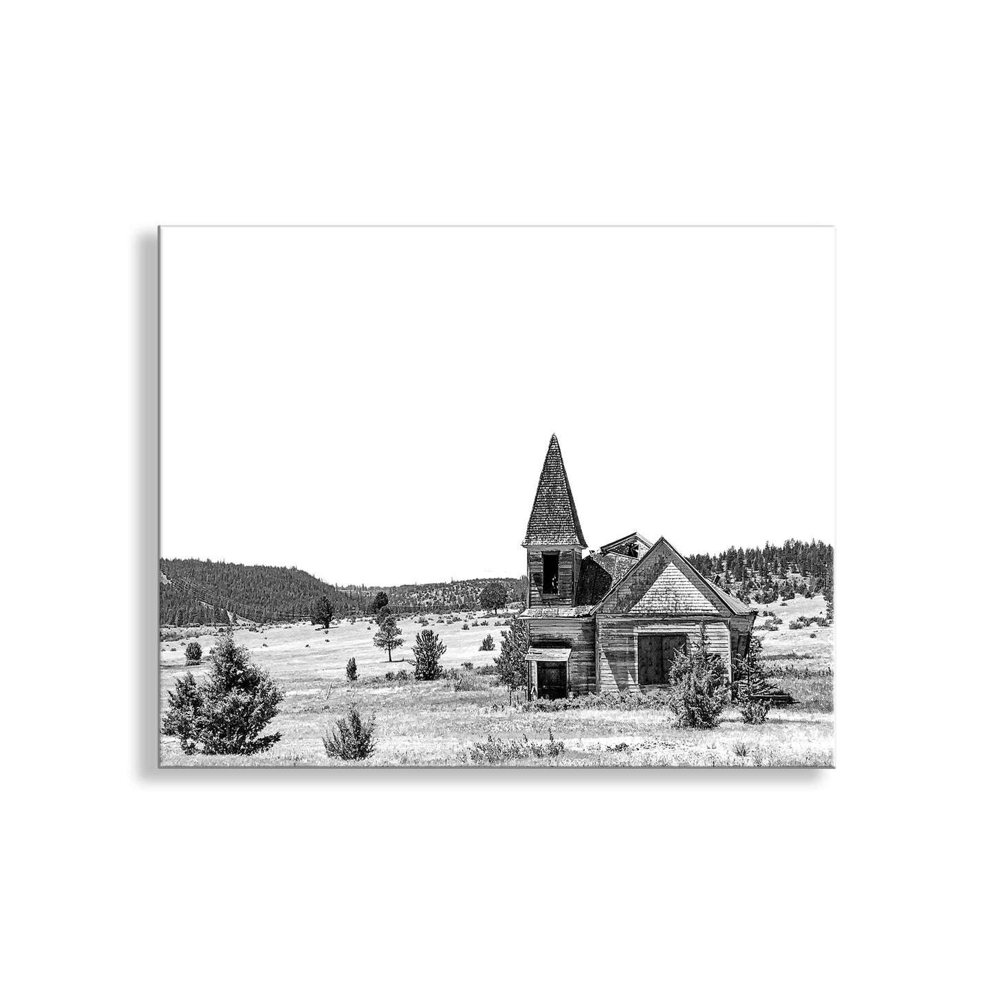 Black and white photograph of an abandoned church in a field with trees in the background. Surreal Black and White Old Western Church Photography Art Print
