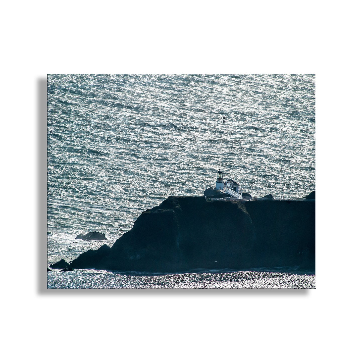 Lighthouse on a rocky island with choppy ocean waters. Guarding the entrance to San Francisco Bay, Point Bonita Lighthouse stands on its own! This is Marin Headlands, in the Golden Gate National Recreation Area of northern California. Original, unique signed art by Murray Bolesta!