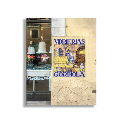 Poster of a man cleaning a window with 'Vidrierás Gordiola' text on a textured wall. Gordiola Mallorca Spain Palma Street Photograph | Spain Travel Wall Art