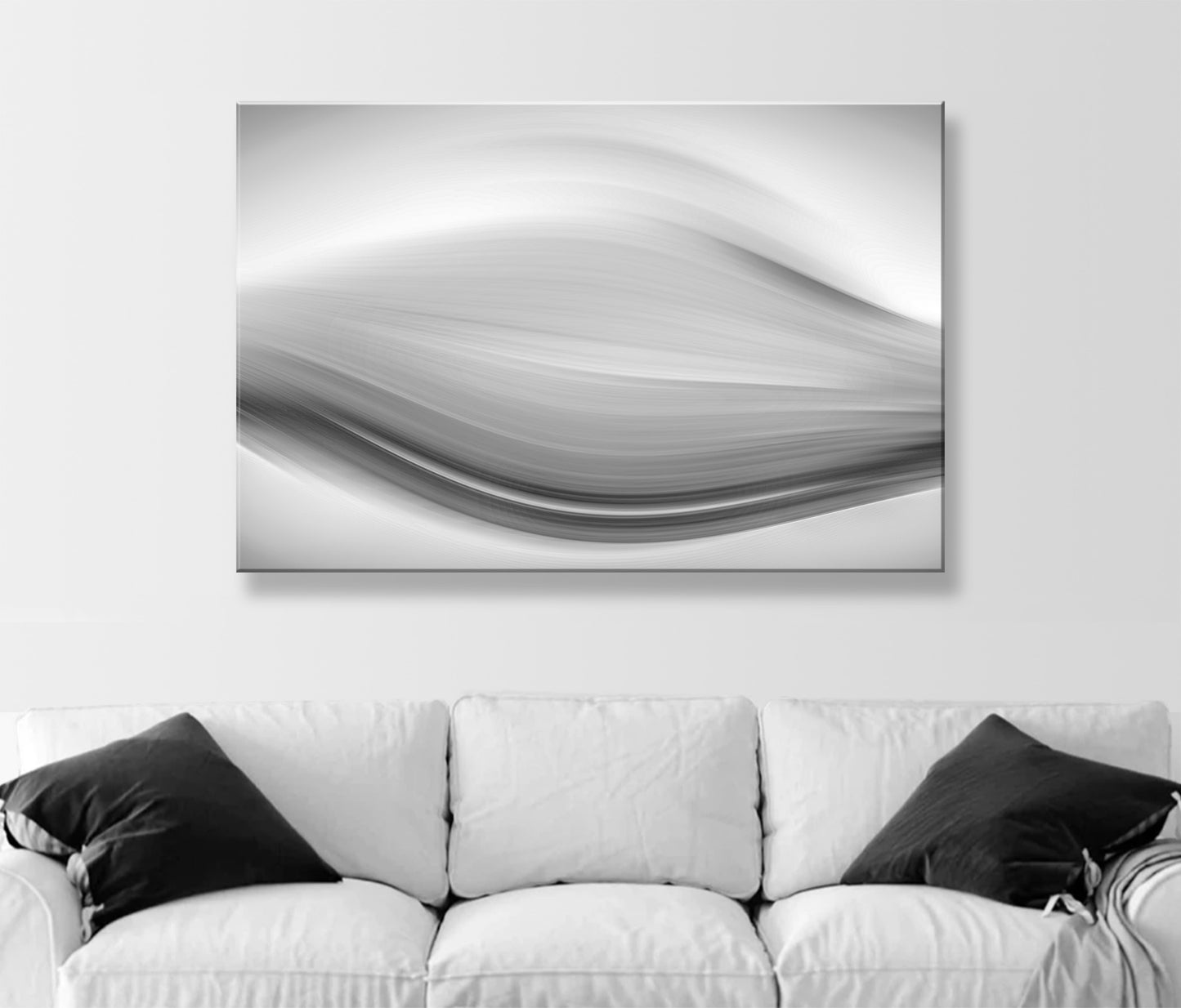 Abstract black and white painting on a wall above a white sofa with black pillows. Black and White Modern Art Print on Framed Canvas