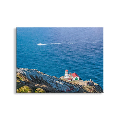 Lighthouse on a cliff overlooking the ocean with a boat in the distance. Point Reyes California Lighthouse Photo Print