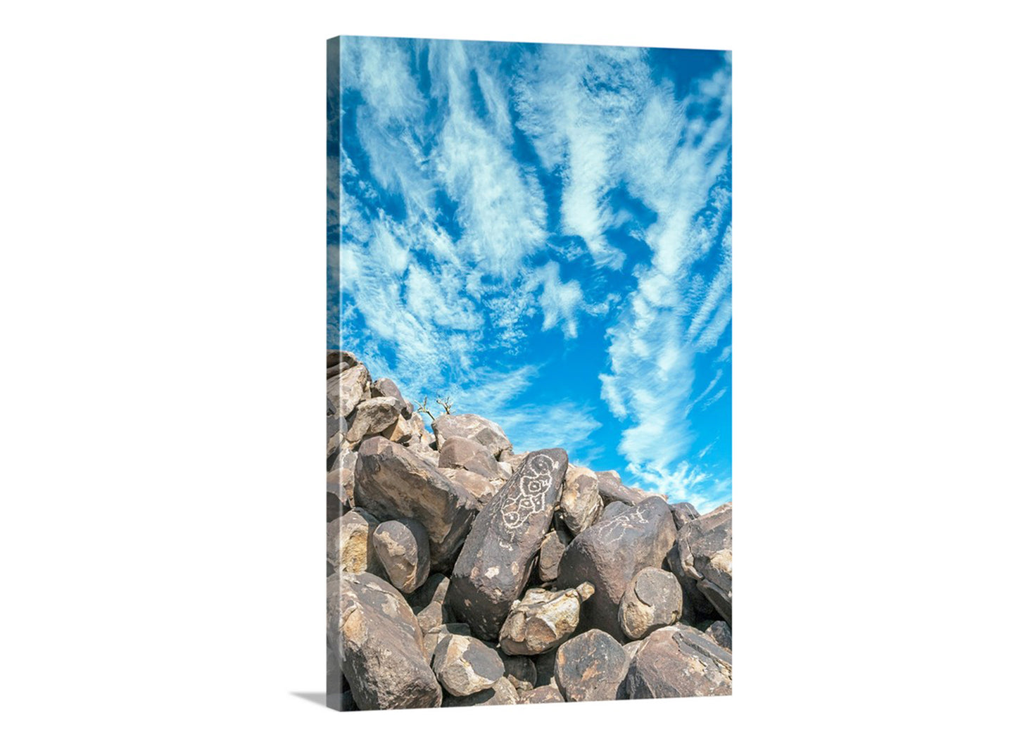 a rocky landscape with a clear blue sky and wispy clouds. Native American Petroglyph | Arizona Desert Southwestern Rock Wall Art