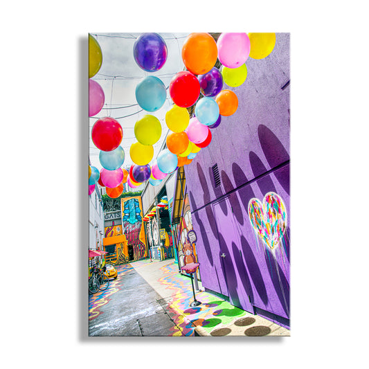 Colorful street scene with balloons and a purple building with a heart design. Fort Mason San Francisco Wall Art – Bright & Colorful Street Photography of Umbrella Alley