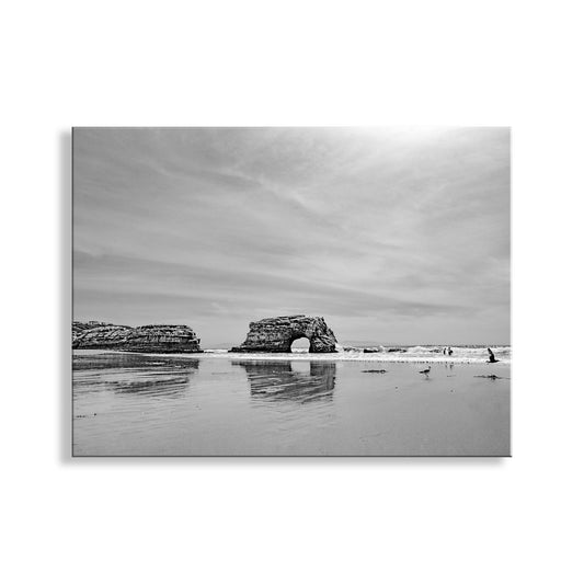 Black and white photograph of coastal cliffs reflected in water with a cloudy sky. Santa Cruz California State Beach | Natural Bridges Art in Black & White