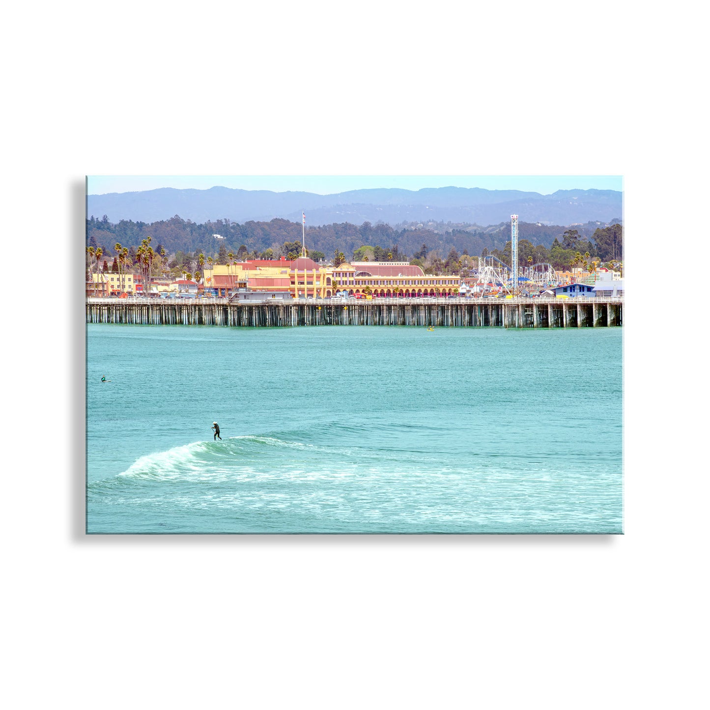 Surfer riding a wave in turquoise water with a pier and buildings in the background. A cool California scene to make you smile! This is the municipal wharf at Santa Cruz California, with the Santa Cruz Beach Boardwalk behind. In the foreground we have a surfer riding a nice, slow relaxed wave. Just my style! Original, unique signed art by Murray Bolesta!