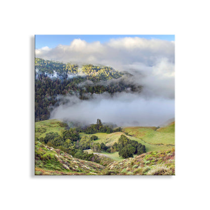 Lush green hills and valleys partially covered by mist on a clear day. Santa Lucia Mountain Landscape Art at Big Sur Coast California