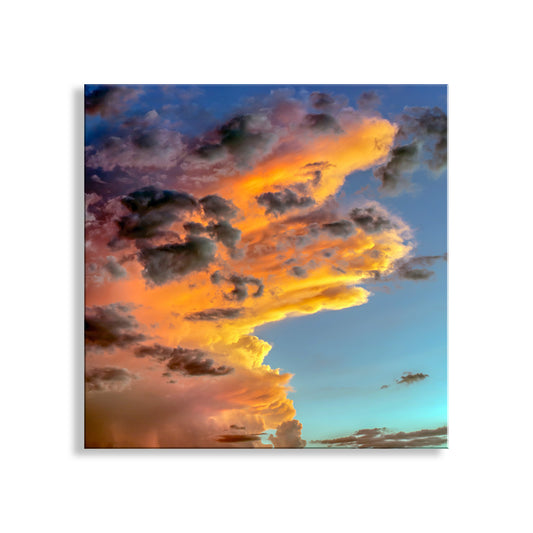 Fiery orange and pink clouds against a blue sky