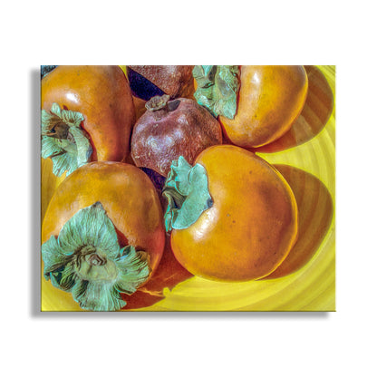 Fruits on a yellow plate with a white background. Southwestern Still Life Food Art with Pomegranate and Persimmon Fruit