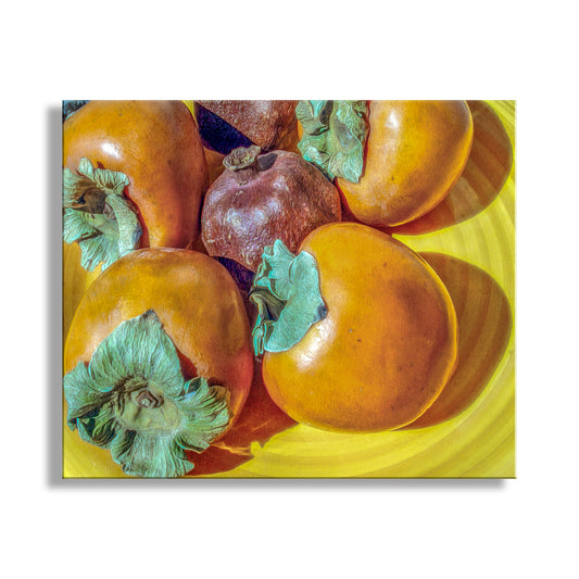 Fruits on a yellow plate with a white background. Southwestern Still Life Food Art with Pomegranate and Persimmon Fruit