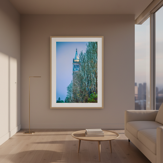 A framed art print of the Campanile tower in Venice, featuring a blue sky, trees, and the tower, presented in a black frame with a white mat against a light gray background.