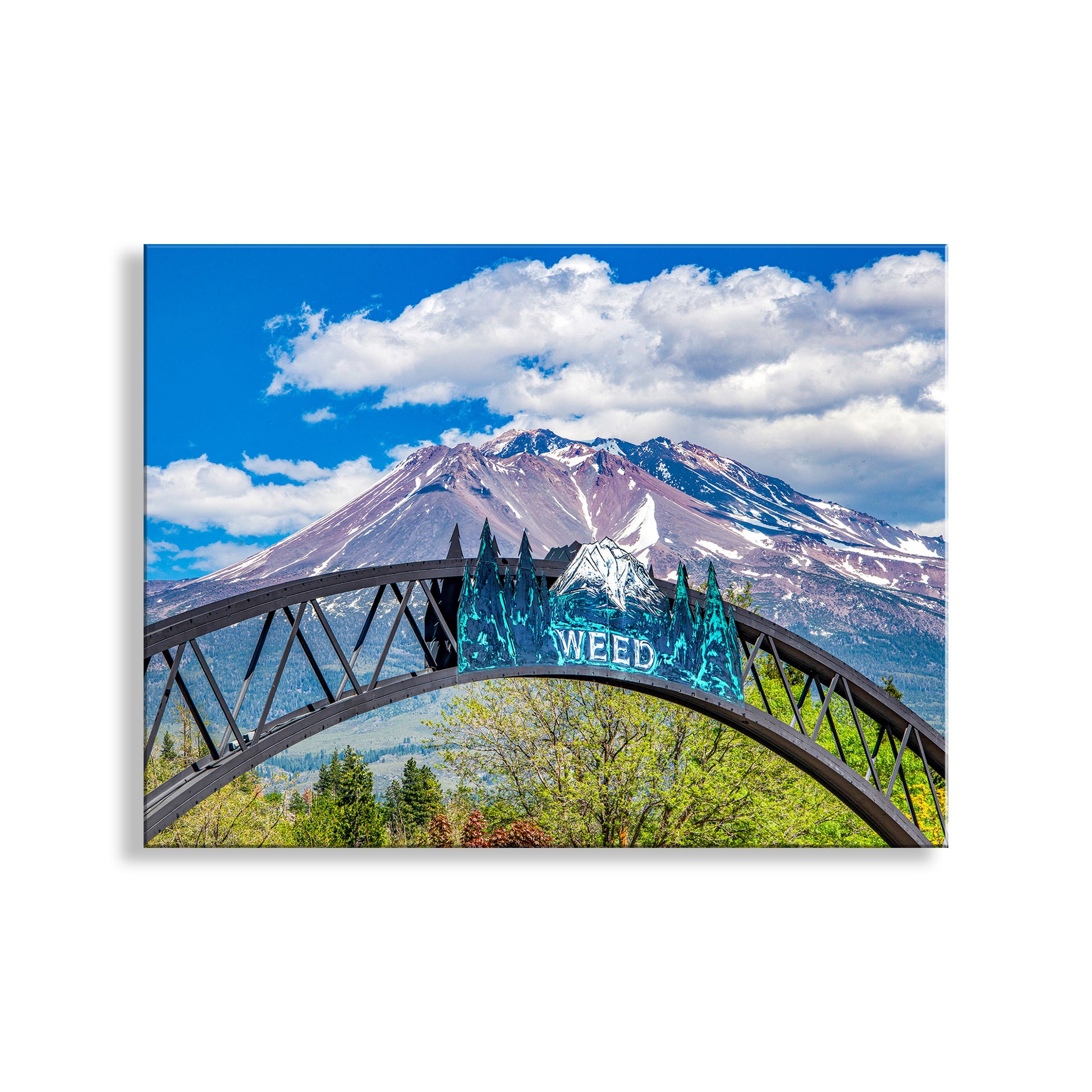Archway with 'WEED' sign in front of a mountain under a blue sky with clouds. Mount Shasta Landscape Art Print in Weed California