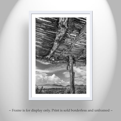 Framed black and white print of a desert landscape with a wooden structure. Tucson Arizona Landscape Art | Desert Ocotillo Ramada in Black & White