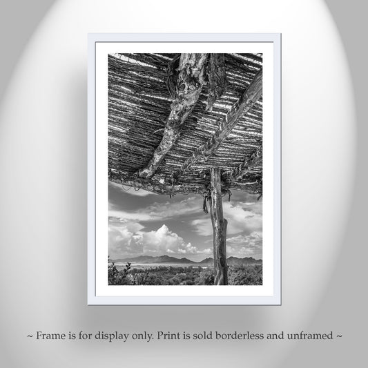 Framed black and white print of a desert landscape with a wooden structure. Tucson Arizona Landscape Art | Desert Ocotillo Ramada in Black & White
