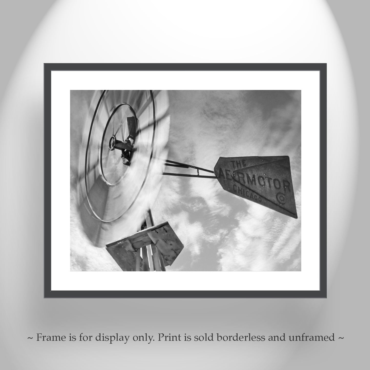 Framed black and white print of a vintage advertisement with a clock and text on a gray background. Rustic windmill wall art: captured on camera by me at the remote Hot Springs Canyon of southern Arizona USA, here's an Aermotor of Chicago windmill from yesteryear. A common sight in the borderlands, many still are very productive like this one! Original, unique signed art by Murray Bolesta.