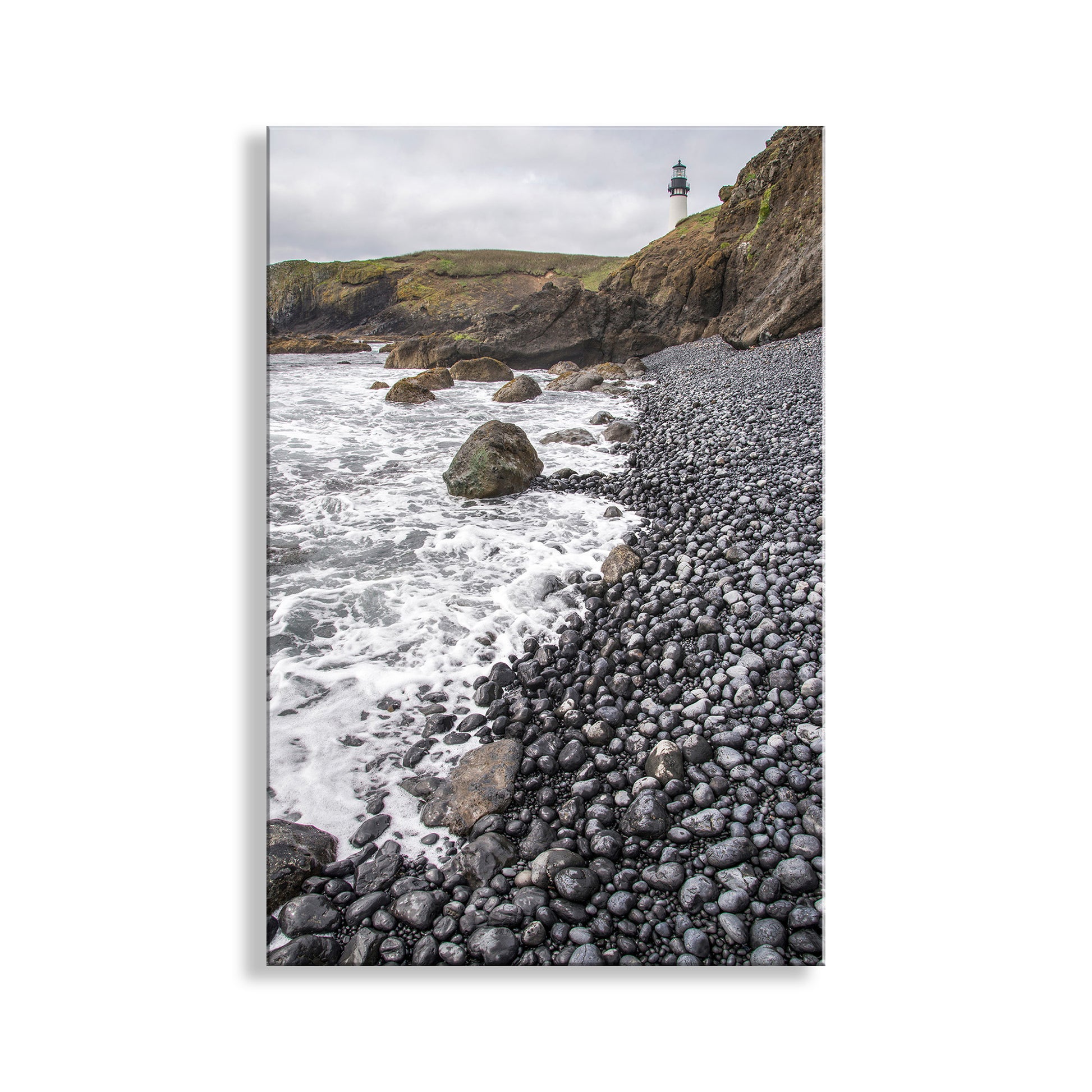 Pebbly beach with ocean waves and a lighthouse on a hillside. Wonderful Yaquina Head. My outstanding Oregon coast lighthouse picture for your viewing enjoyment. This is Yaquina Head Outstanding Natural Area, a wonderful Bureau of Land Management property. All public lands must become permanently preserved! Original, unique signed art &nbsp;by Murray Bolesta.