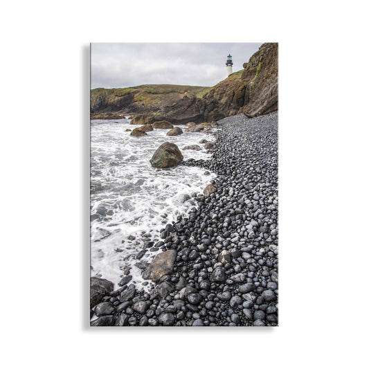 Pebbly beach with ocean waves and a lighthouse on a hillside. Wonderful Yaquina Head. My outstanding Oregon coast lighthouse picture for your viewing enjoyment. This is Yaquina Head Outstanding Natural Area, a wonderful Bureau of Land Management property. All public lands must become permanently preserved! Original, unique signed art &nbsp;by Murray Bolesta.