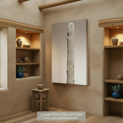 A vertical canvas wall art print featuring a tall saguaro cactus in black and white, shown at a slight angle against a neutral gradient background. Gila Woodpecker Ironwood Forest by Murray Bolesta!