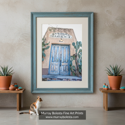 A photo of a southwestern style building with a blue barrio door, titled 'Elylsian Grove'. Tucson Arizona Art by Murray Bolesta.