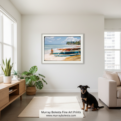 A framed art print depicting a tropical beach scene with traditional boats on a sandy shore, displayed on a wall in a modern, sunlit living room with a dog sitting nearby.