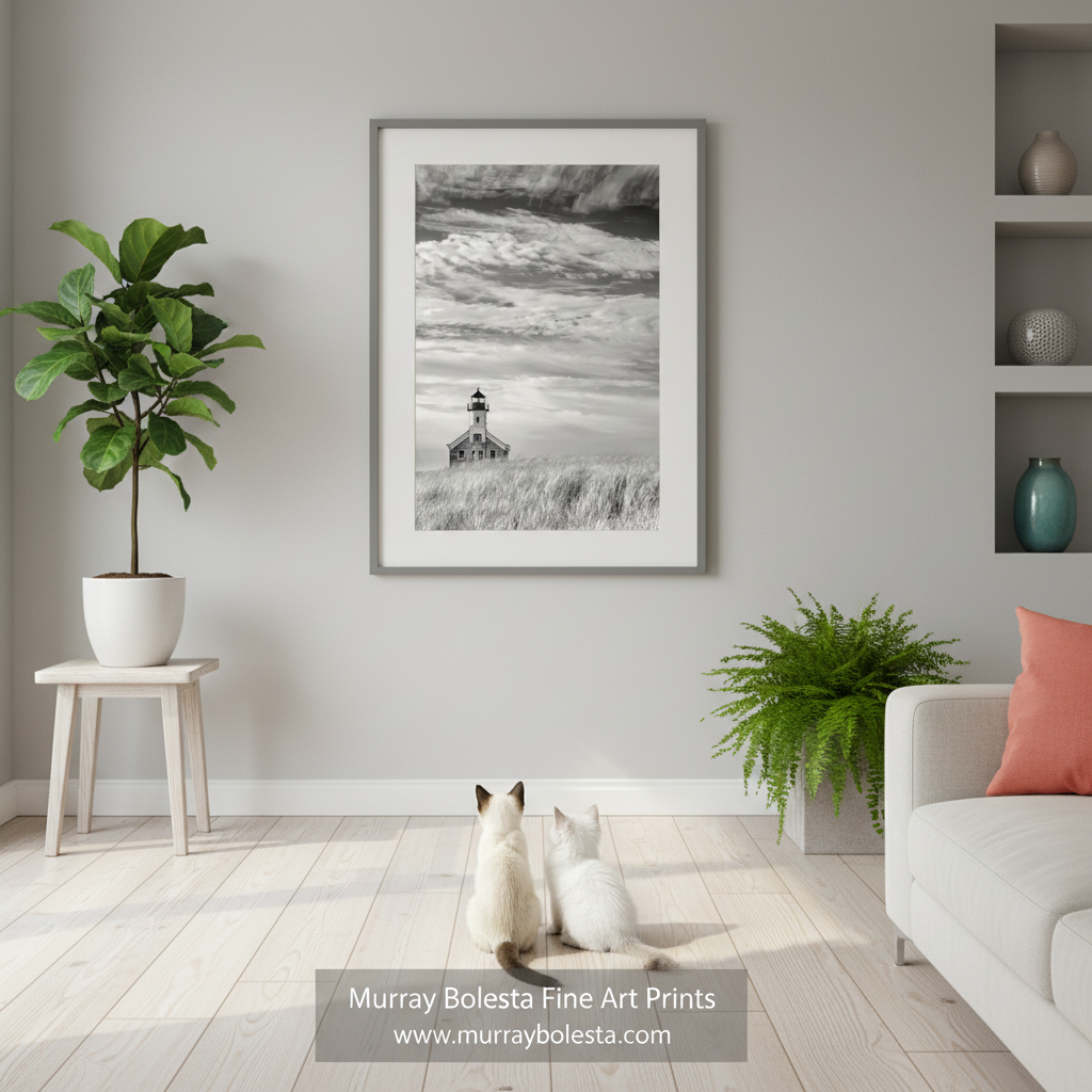 A sepia photograph of a lighthouse standing in a field of tall grass, with a cloudy sky in the background. Block Island Lighthouse Fine Art Print | Dreamy Rhode Island Art by Murray Bolesta!