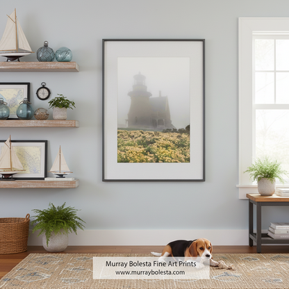 A lighthouse stands in the distance, partially obscured by fog, with a field of yellow flowers in the foreground. Block Island South East Lighthouse Photo | Foggy Rhode Island Art by Murray Bolesta