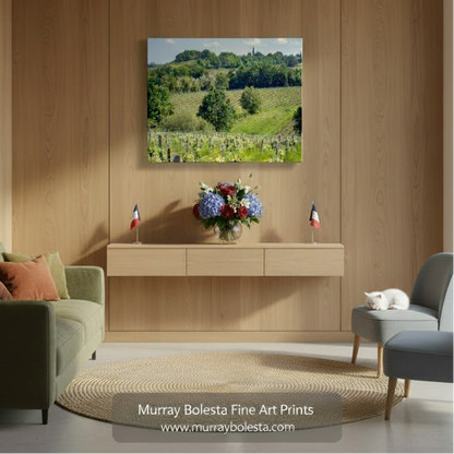 A picturesque countryside landscape with vineyards, rolling hills, and a church spire in the distance. French Vineyard Photography Bordeaux | Wine Country Landscape Art by Murray Bolesta