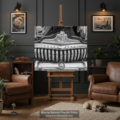 Buick Car art! A framed black-and-white art print depicting a vintage car grille and emblem, displayed on a wooden easel in a styled living room with brown leather armchairs, potted plants, wall sconces, and a small dog on a rug. The text 'Murray Bolesta Fine Art Prints' appears at the bottom.