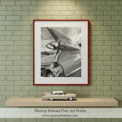 The image is a black and white photograph of a chrome car's tail fins, Cadillac Tail Fins Picture – Black & White Classic Car Art by Murray Bolesta