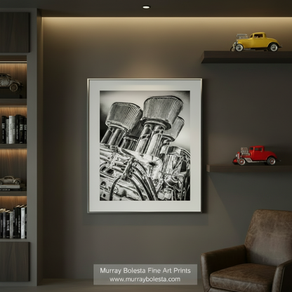 A black and white image depicting a complex mechanical device with multiple components, including pipes and cylinders, arranged in a visually striking manner. Vintage Black & White Hot Rod Muscle Car Art Print by Murray Bolesta