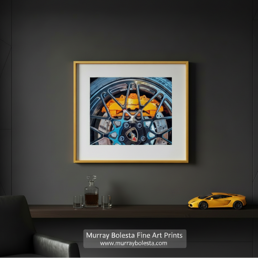a close-up view of a black Lamborghini wheel with a distinctive orange brake caliper. amborghini Automotive Art – Italian Supercar Sports Car by Murray Bolesta