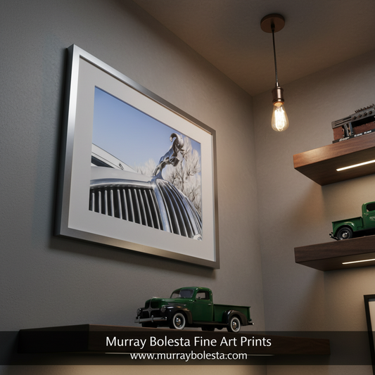 A close-up view of a chrome hood ornament on a car, with a clear blue sky in the background. Dodge Ram Truck Art Print as Vintage Automotive Wall Decor by Murray Bolesta