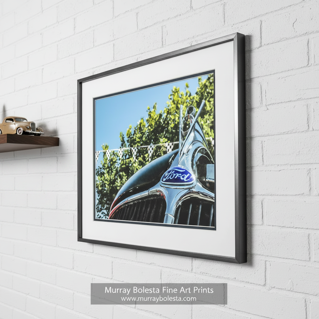 a close-up view of a classic Ford car's hood, featuring the iconic Ford emblem and grill. Vintage Ford V8 Old Car Picture as Wall Art by Murray Bolesta