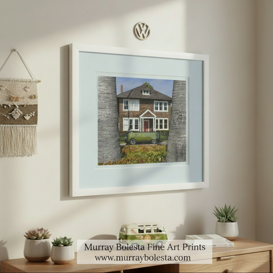 A two-story wooden house with a red door and white trim, surrounded by palm trees, with a green van parked in front of it. VW Bus Art – Custom Vintage Minivan Convertible Picture by Murray Bolesta