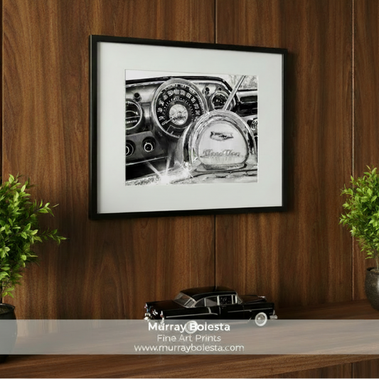 A black and white photograph of the dashboard of a classic car, focusing on the speedometer and the Chevrolet logo. Chevrolet 210 Art Print | Classic Black & White Car Wall Decor by Murray Bolesta