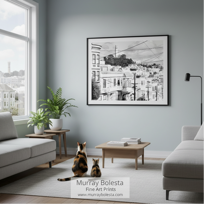 Coit Tower San Francisco! A framed black and white architectural cityscape print hangs on a light gray wall in a modern living room with gray sofas, plants, and two cats sitting on the floor. The text 'Murray Bolesta Fine Art Prints' appears at the bottom.