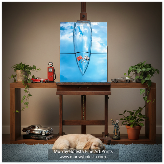 Classic Corvette by Murray Bolesta! A square canvas art print hanging on an easel above a wooden console table. The artwork depicts a blue sky with white clouds and a white airplane.