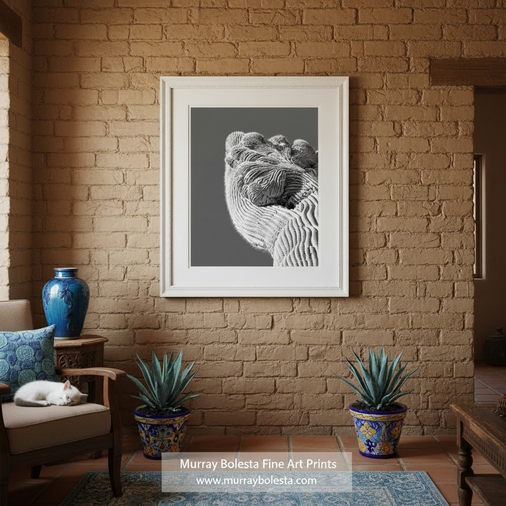 A close-up black and white image of a textured, intricate sculpture or artwork, with a dark background. Crested Saguaro Cactus Art Print - Black & White Desert Abstract by Murray Bolesta