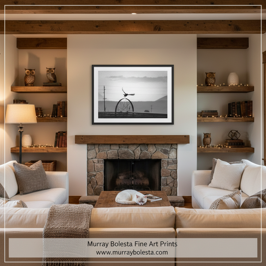 Farm Owl by Murray Bolesta! A framed black and white art print of an owl in living room setting above a stone fireplace, flanked by built-in shelves with decorative items and two cream-colored sofas.