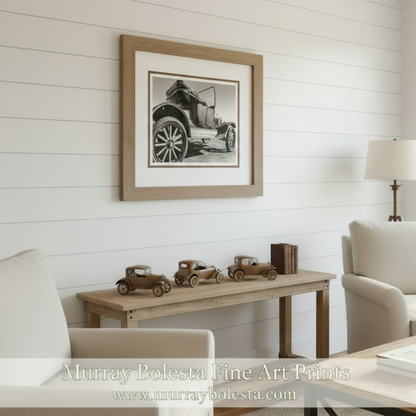 A black and white photograph of an old-fashioned car with its door open, showcasing the vehicle's design and features. Antique Ford Model T Roadster Picture – Sepia Toned Art by Murray Bolesta