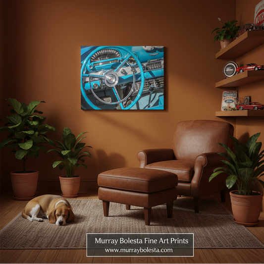 A framed wall art print showing a vintage blue car steering wheel and dashboard, displayed in a warm brown living room above a brown leather armchair and ottoman. A dog lies on the rug nearby, with potted plants and wooden shelves in the room.