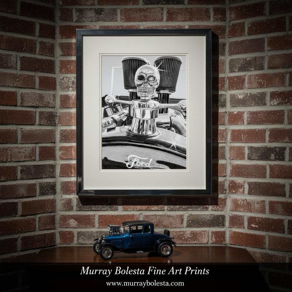 A close-up black and white photograph of a Ford vehicle, featuring a chrome hood ornament with a skull design and two large air filters. Hot Rod Muscle Car Art Canvas in Black and White | Ford Model T by Murray Bolesta