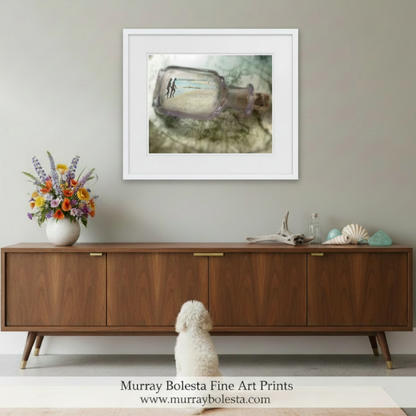 Framed artwork of a bottle with a message on a beach, France nude beach in a bottle art by Murray Bolesta