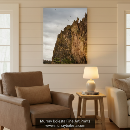 a rocky cliff with a flock of birds flying above it, set against a cloudy sky. Soaring Hawks at Smith Rock - Oregon Desert Landscape Bird Art Print by Murray Bolesta
