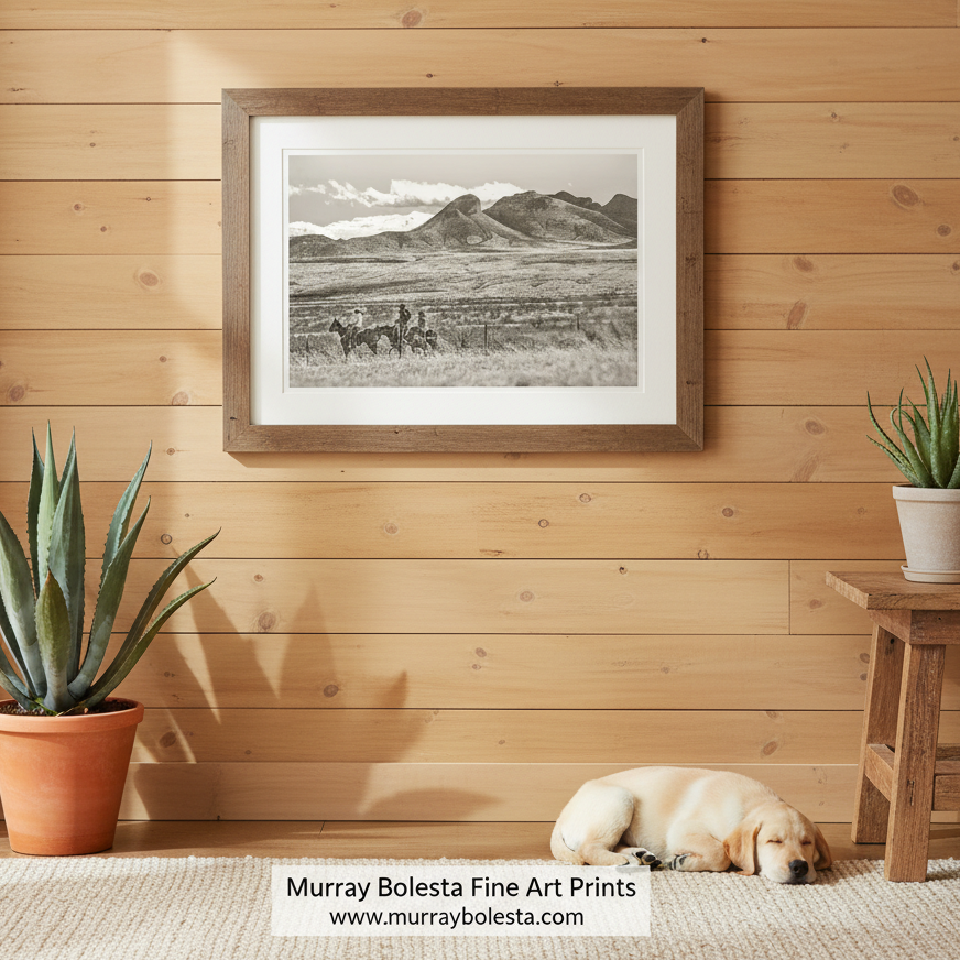 A sepia photograph depicting two cowboys riding horses in a vast, open field with mountains in the distance. Cowboy Art Print Empire Ranch | Western Equestrian Wall Decor by Murray Bolesta